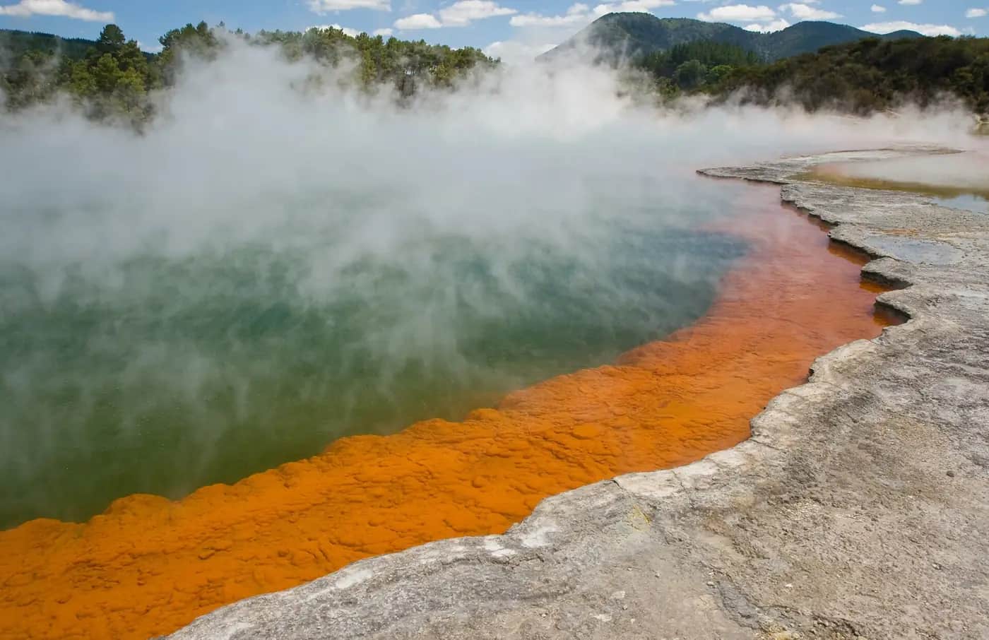 Steam rising from the orange-edged Champagne Pool at Wai-O-Tapu geothermal area
